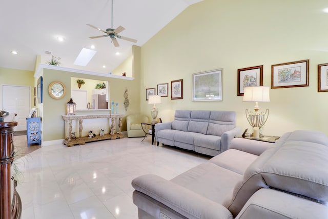 tiled living room featuring a skylight, high vaulted ceiling, and ceiling fan