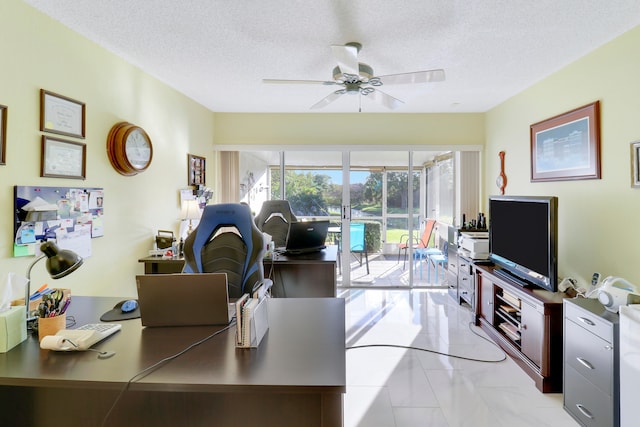 office space featuring ceiling fan and a textured ceiling