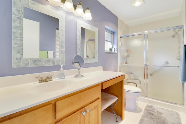 bathroom featuring tile patterned flooring, vanity, toilet, and a shower with shower door