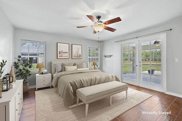 bedroom with a textured ceiling, wood finished floors, french doors, baseboards, and access to exterior