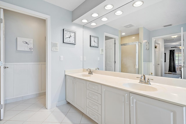 full bathroom featuring tile patterned flooring, a shower stall, visible vents, and a sink