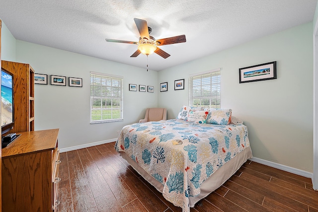 bedroom with multiple windows, baseboards, and dark wood-style flooring