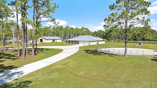 surrounding community featuring concrete driveway and a yard