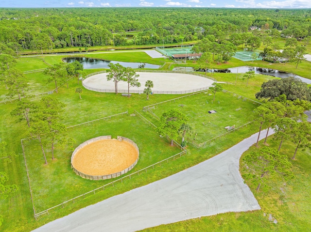 birds eye view of property with a forest view and a water view