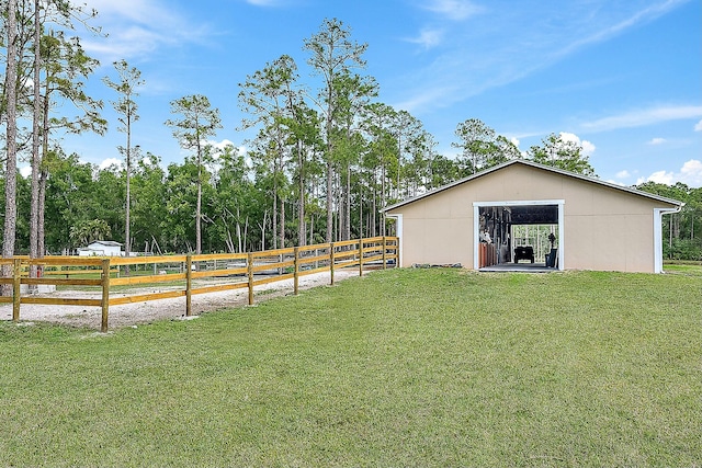 view of yard with an outbuilding and fence