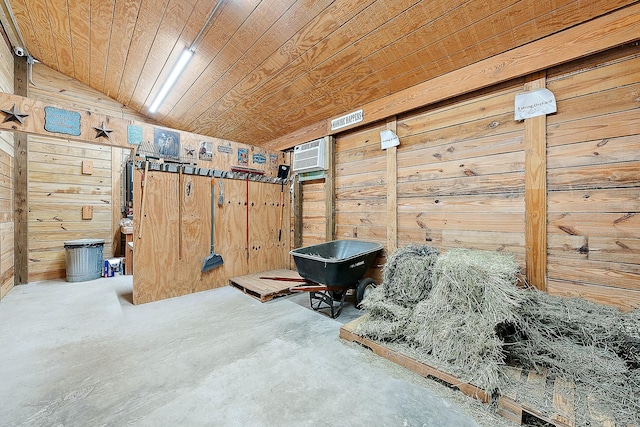 interior space with wood walls, wood ceiling, unfinished concrete flooring, and a wall unit AC