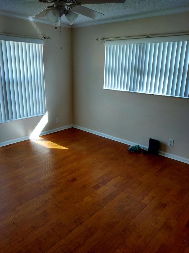 9890 Bischofia Tree Way Unit A, Boynton Beach, FL 33436 - unfurnished room with a ceiling fan, plenty of natural light, wood finished floors, crown molding, and baseboards