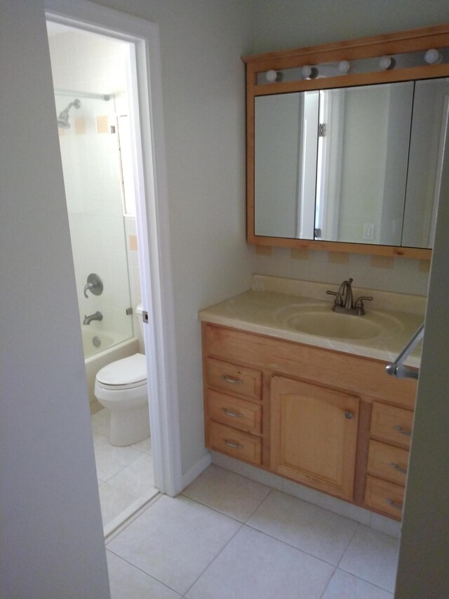 9890 Bischofia Tree Way Unit A, Boynton Beach, FL 33436 - bathroom featuring toilet, tile patterned flooring, vanity, and washtub / shower combination