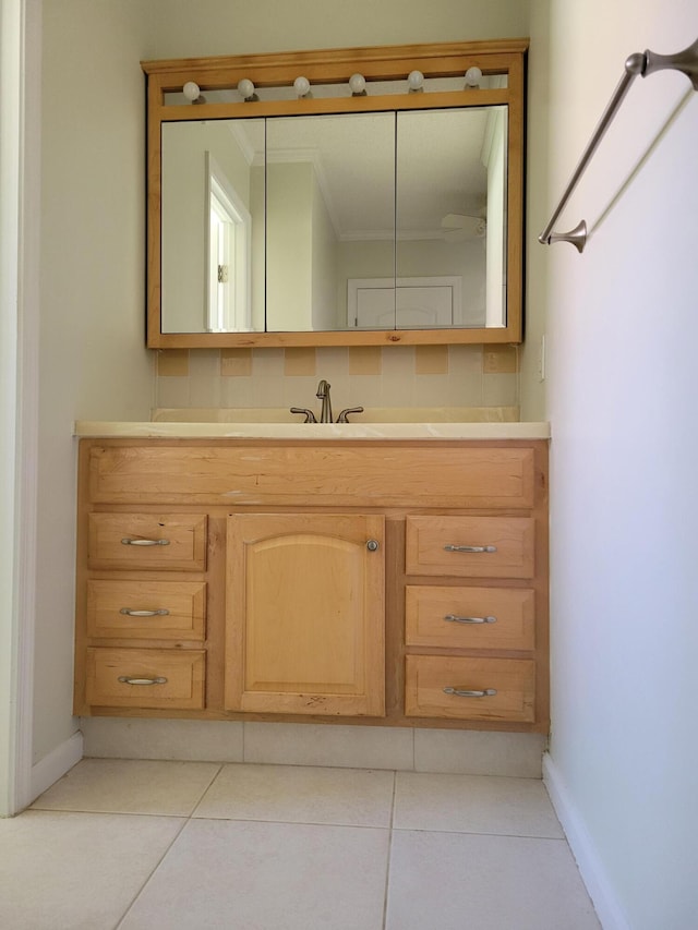 9890 Bischofia Tree Way Unit A, Boynton Beach, FL 33436 - bathroom with ornamental molding, baseboards, tile patterned floors, and vanity