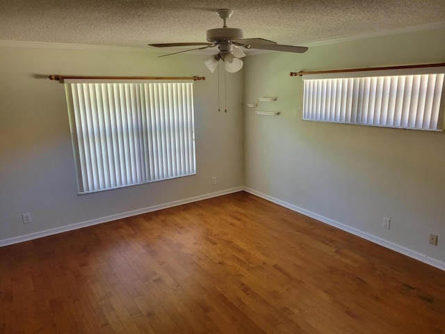 empty room with wood-type flooring, a textured ceiling, ceiling fan, and crown molding