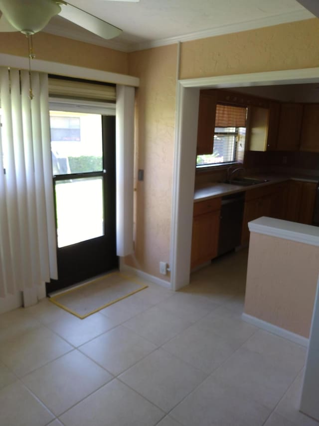 9890 Bischofia Tree Way Unit A, Boynton Beach, FL 33436 - kitchen with dishwasher, a sink, ornamental molding, light tile patterned flooring, and brown cabinetry