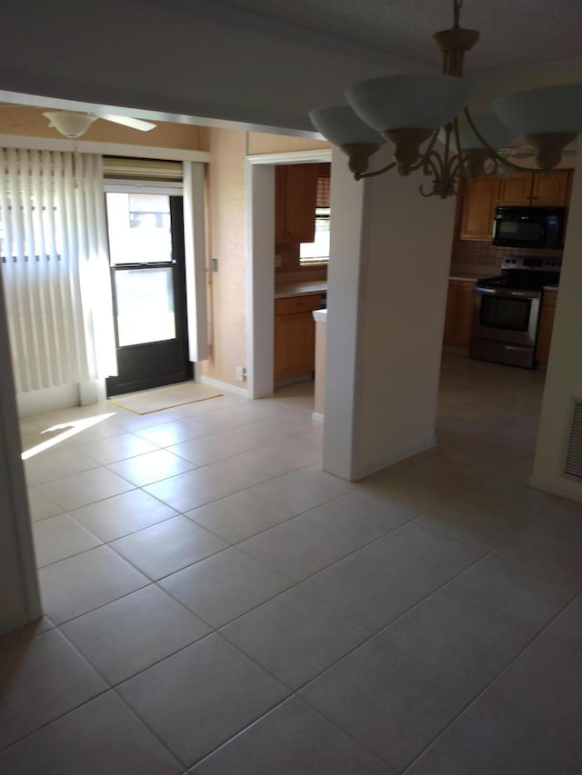 foyer with an inviting chandelier and light tile patterned floors