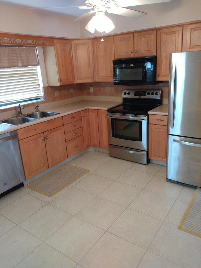 9890 Bischofia Tree Way Unit A, Boynton Beach, FL 33436 - kitchen featuring stainless steel appliances, a sink, light countertops, a ceiling fan, and tasteful backsplash