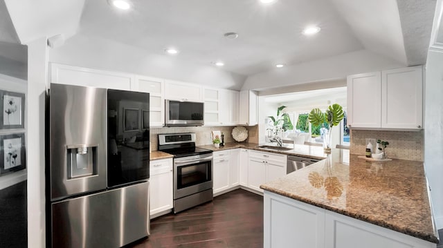 kitchen featuring white cabinets, stainless steel appliances, kitchen peninsula, and stone countertops