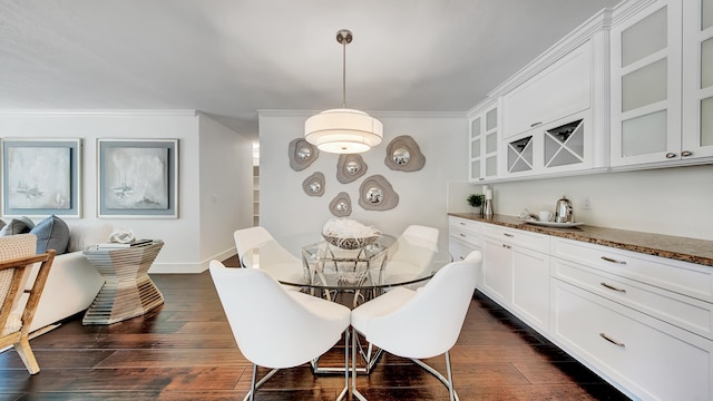 dining room featuring crown molding and dark hardwood / wood-style floors