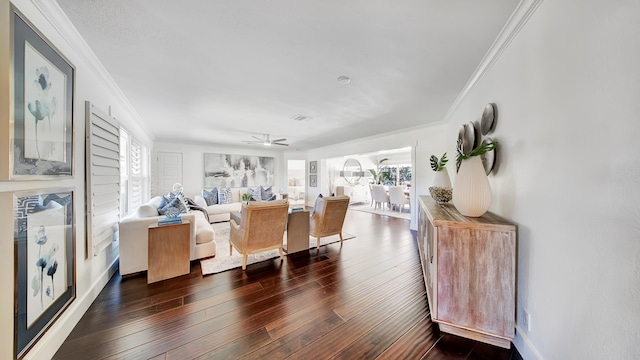 living room featuring ceiling fan, crown molding, and dark wood-type flooring