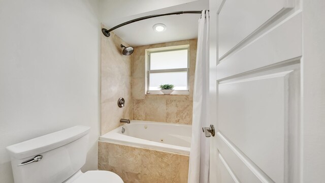 bathroom featuring shower / bathtub combination with curtain and toilet