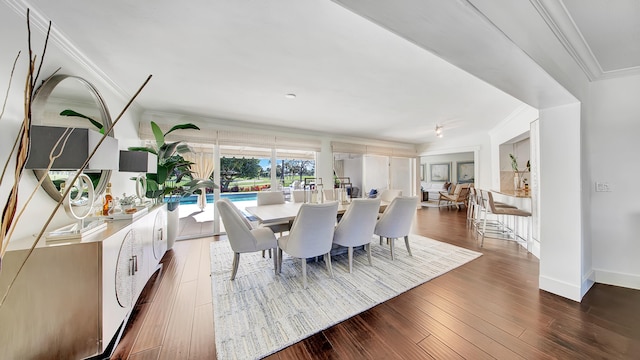 dining room with dark hardwood / wood-style floors and ornamental molding