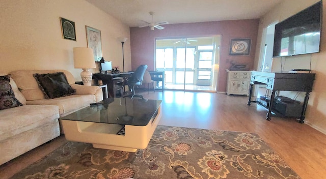 living room featuring hardwood / wood-style flooring and ceiling fan