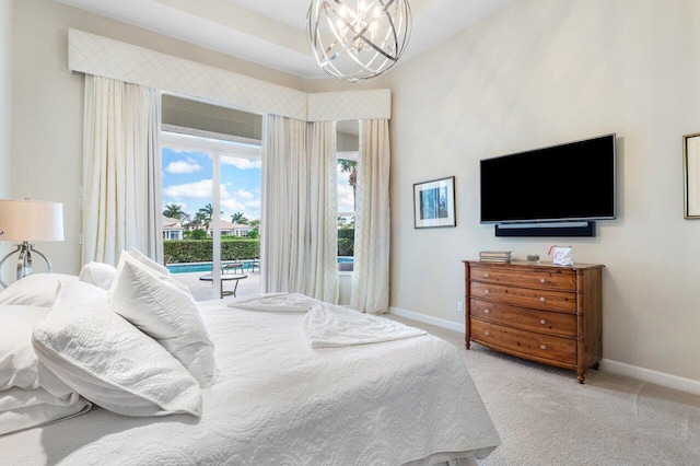 bedroom with access to exterior, light carpet, and a notable chandelier