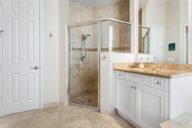 bathroom with tile patterned flooring, vanity, and an enclosed shower