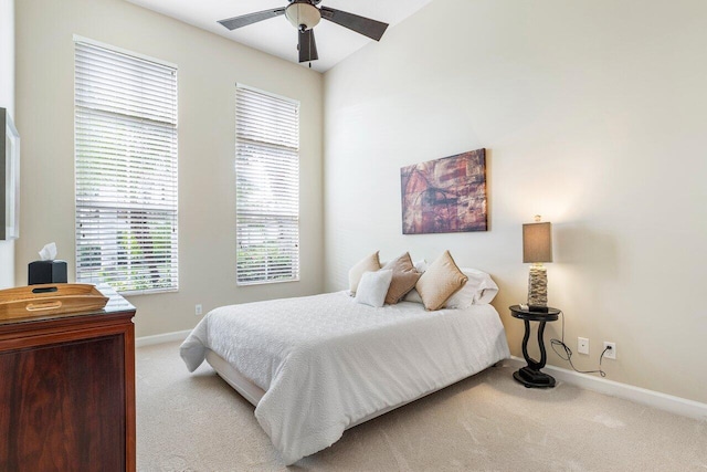 bedroom featuring ceiling fan, carpet, and lofted ceiling