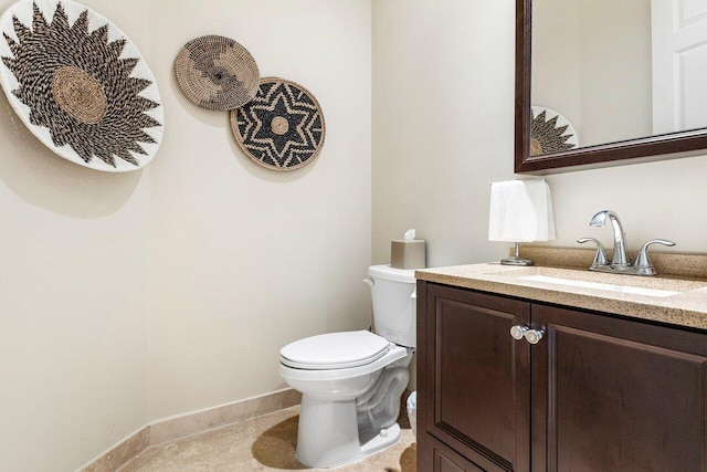 bathroom with tile patterned floors, vanity, and toilet