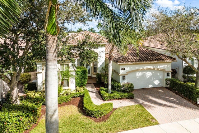 mediterranean / spanish-style home with a garage