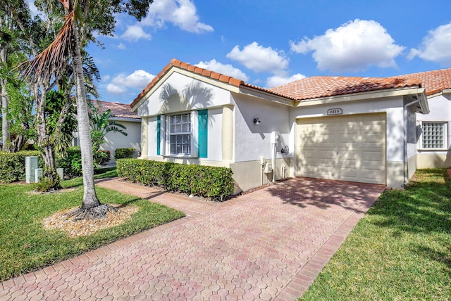 mediterranean / spanish-style house featuring a garage and a front lawn