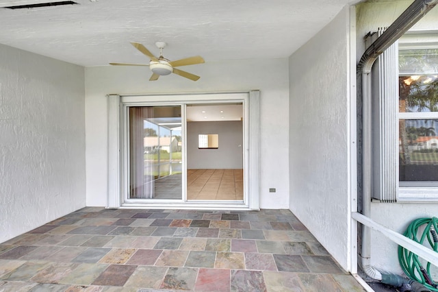 exterior space featuring ceiling fan