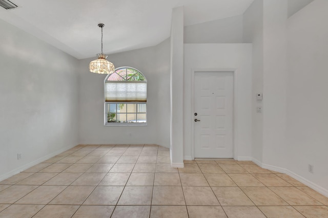 tiled foyer featuring an inviting chandelier and vaulted ceiling