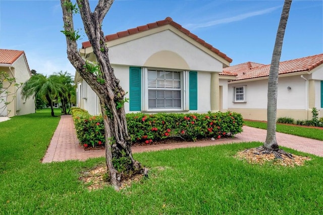 mediterranean / spanish house featuring a front lawn