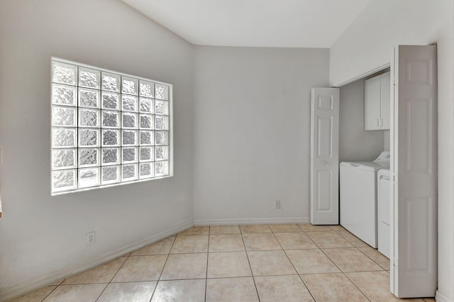 laundry area with light tile patterned flooring, cabinets, and separate washer and dryer