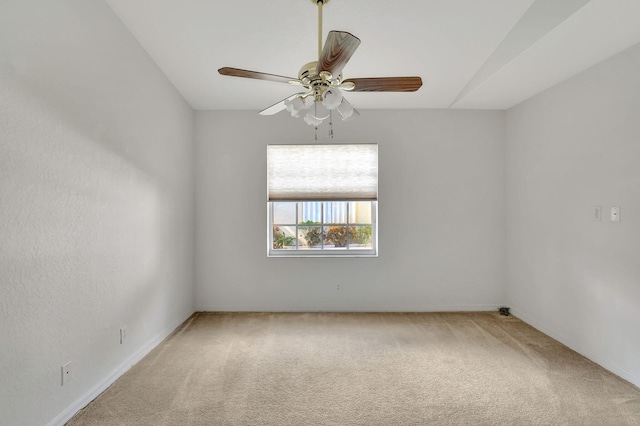 carpeted spare room featuring ceiling fan and vaulted ceiling