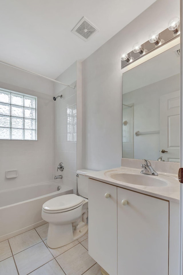 full bathroom featuring toilet, tile patterned flooring, vanity, and tiled shower / bath