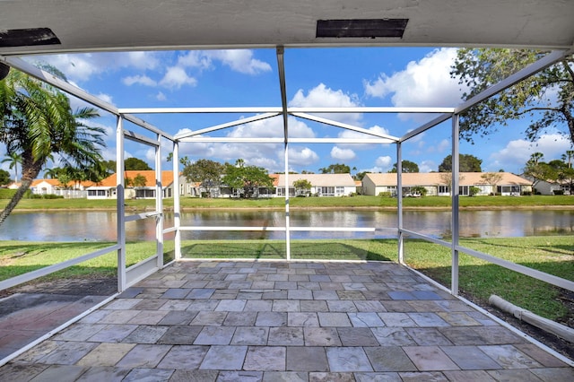 unfurnished sunroom with a water view