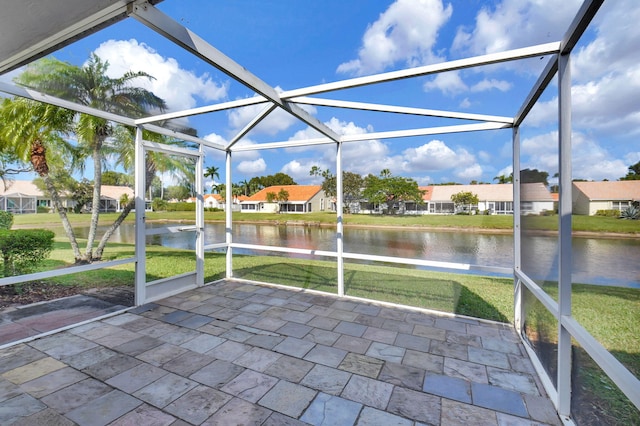 unfurnished sunroom with a water view