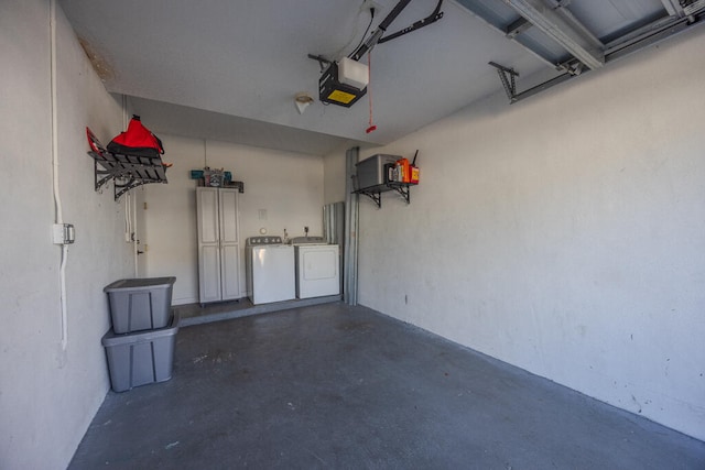 garage with washer and clothes dryer and a garage door opener