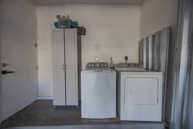 clothes washing area with washer and clothes dryer