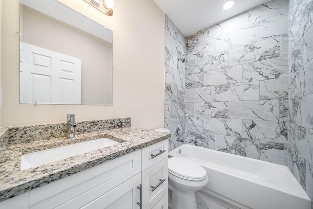 full bathroom featuring vanity, toilet, and tiled shower / bath