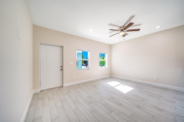 empty room with ceiling fan and light wood-type flooring