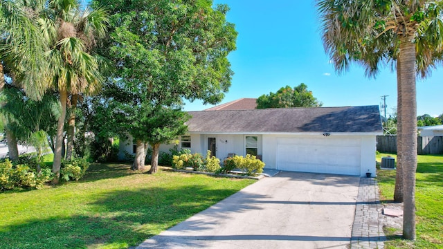 ranch-style house with a garage, a front yard, and central AC