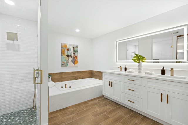 bathroom featuring vanity and separate shower and tub