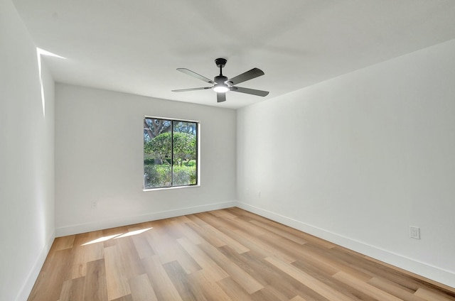 spare room featuring light hardwood / wood-style floors and ceiling fan