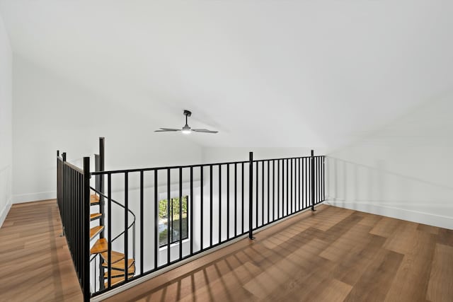 hall featuring lofted ceiling and hardwood / wood-style floors