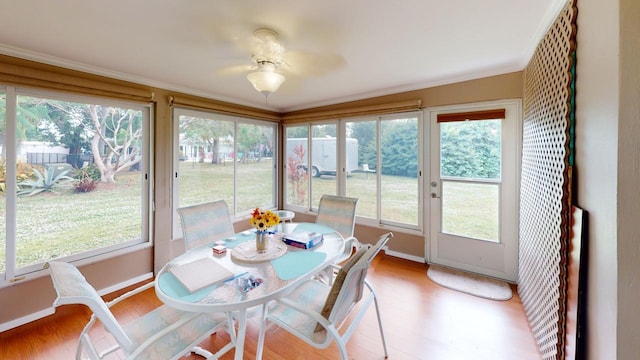 sunroom / solarium featuring ceiling fan