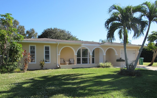 back of property featuring a yard and a garage