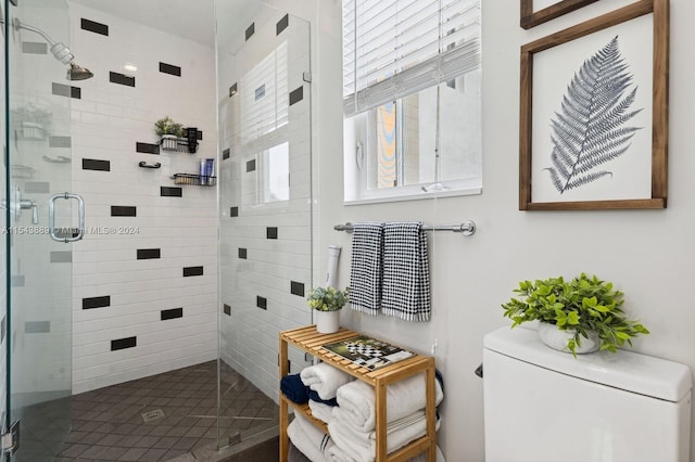 bathroom featuring toilet and an enclosed shower