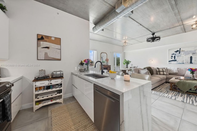 kitchen with kitchen peninsula, sink, white cabinets, and appliances with stainless steel finishes