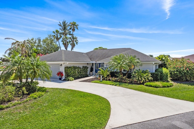 ranch-style home with a garage and a front lawn